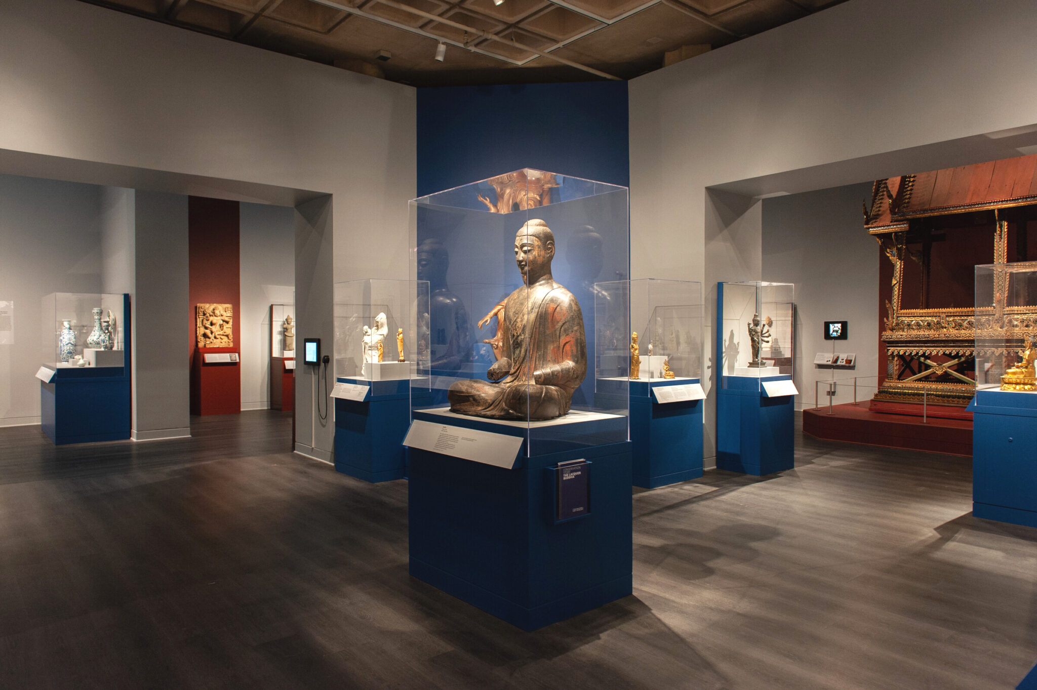 View of gallery with many art objects in cases