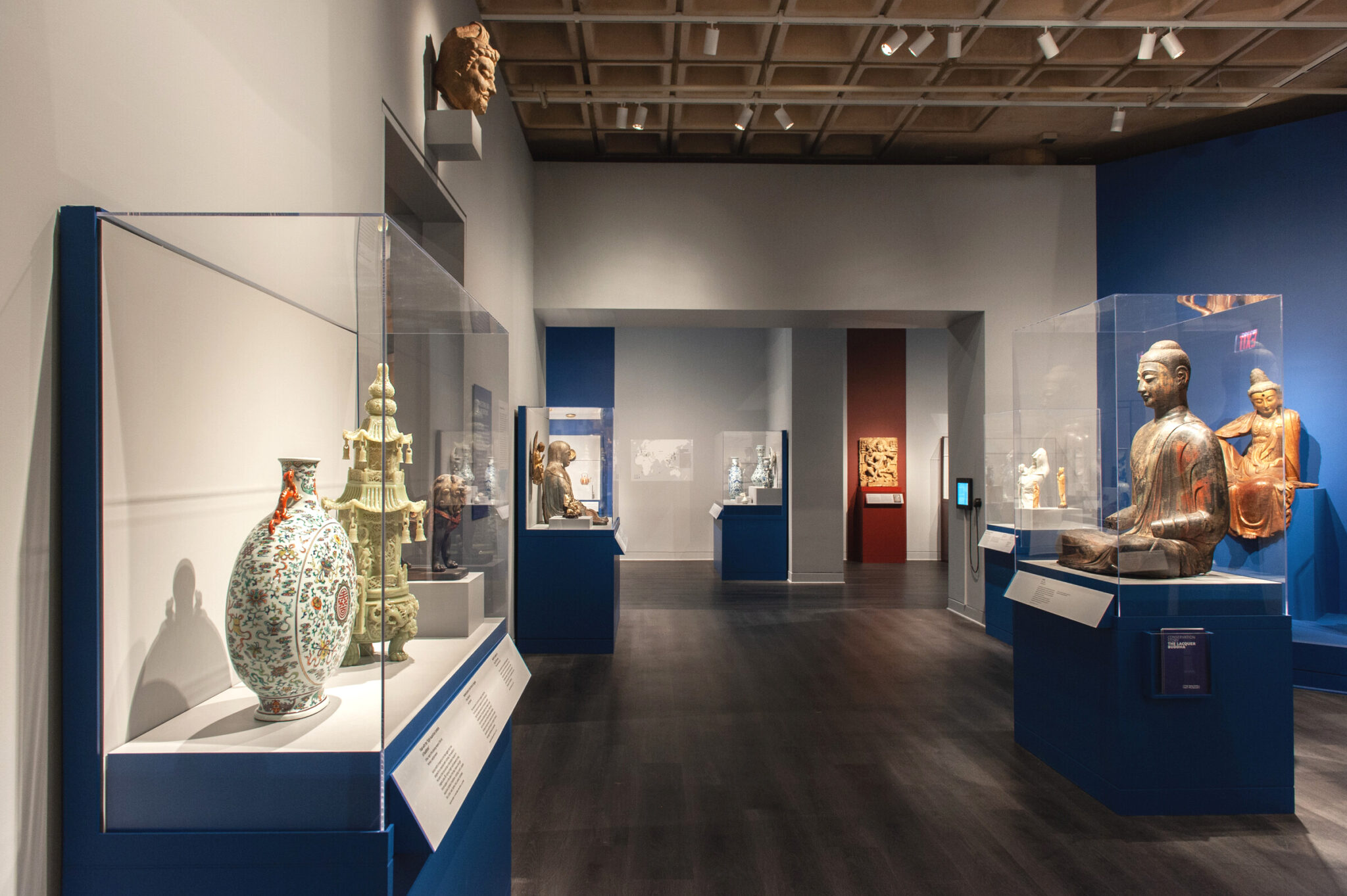 View of gallery with many art objects in cases