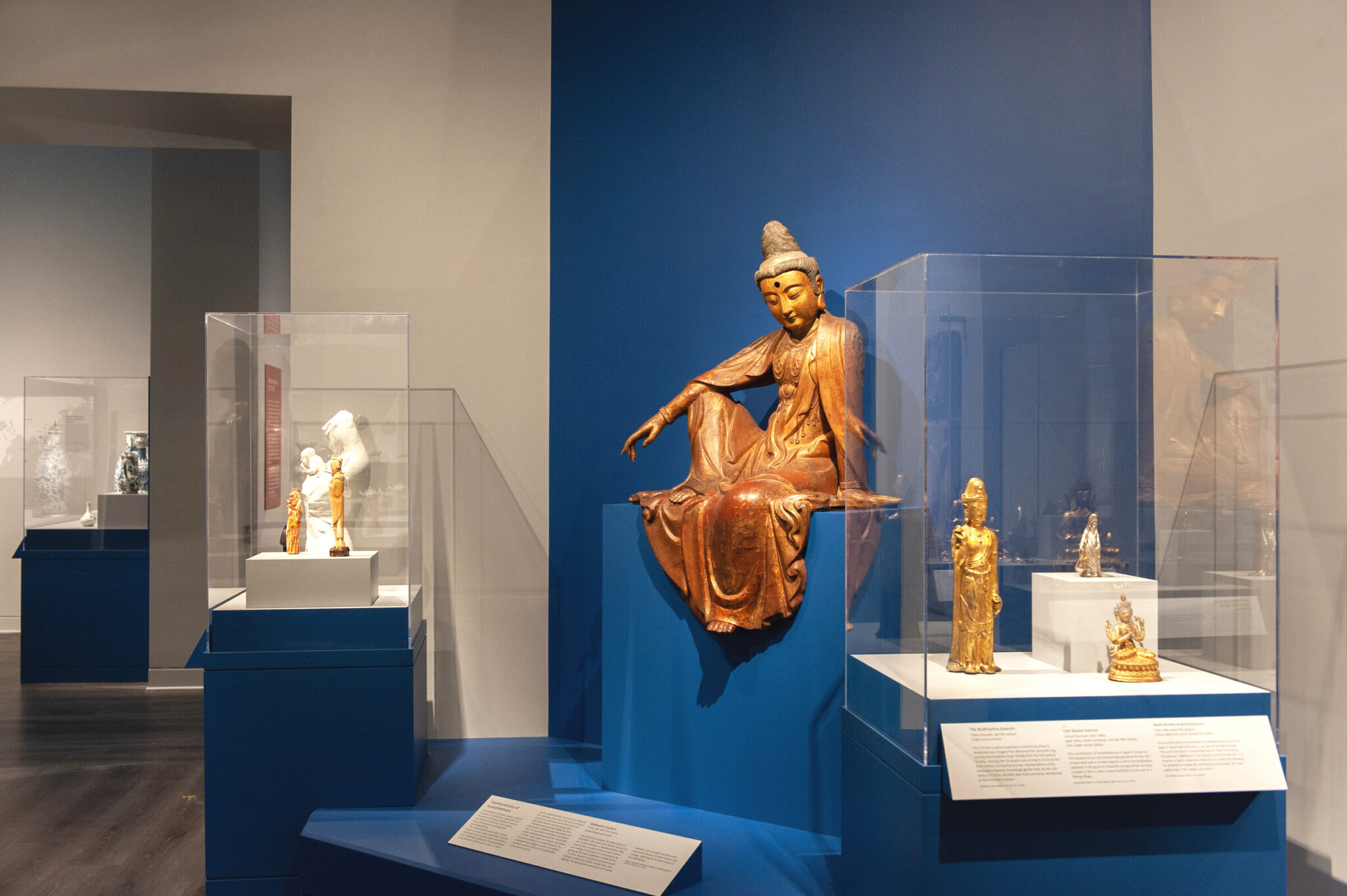 Bodhisattva Guanyin among other art objects in cases