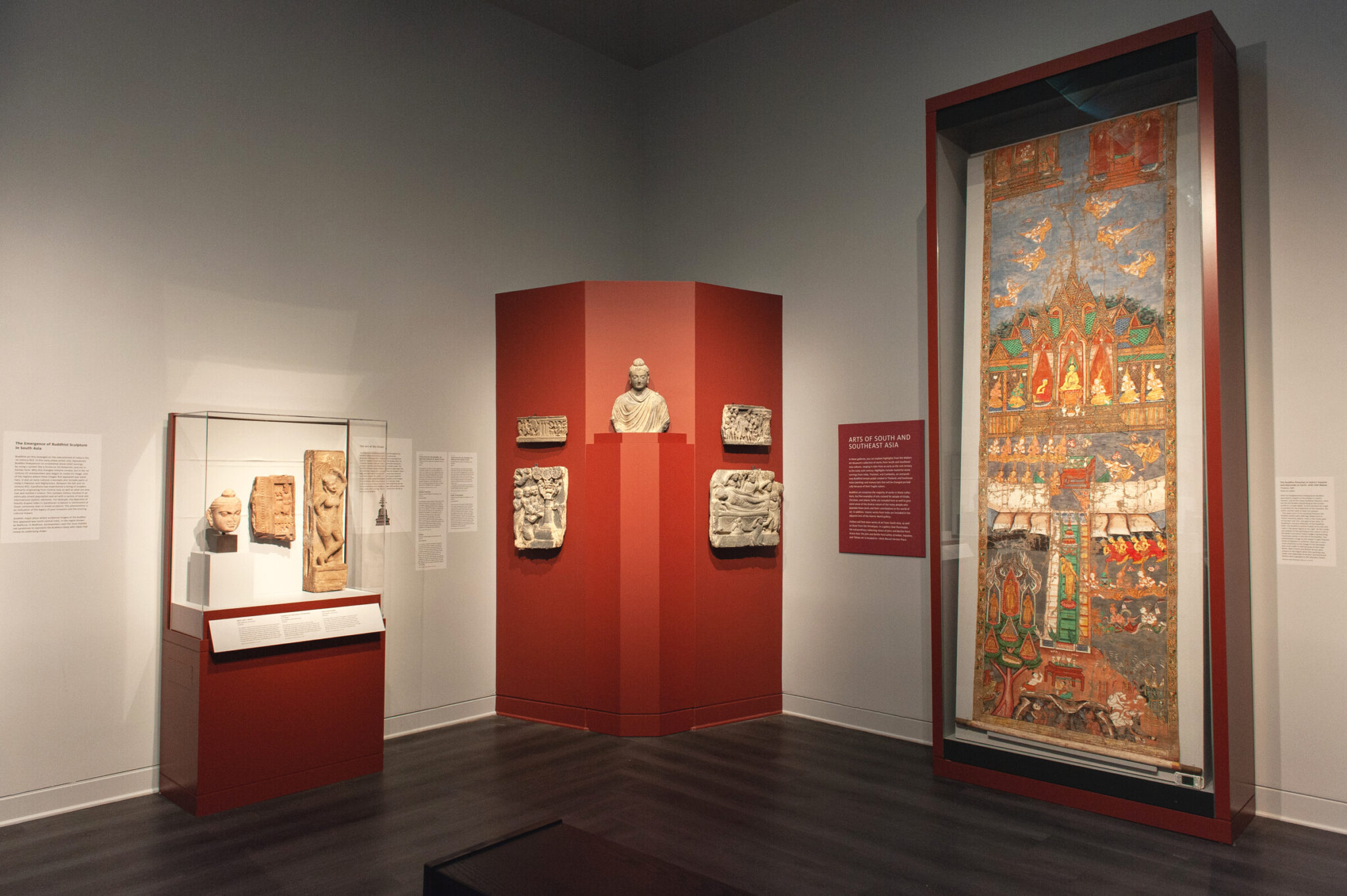 Corner of gallery with many art objects