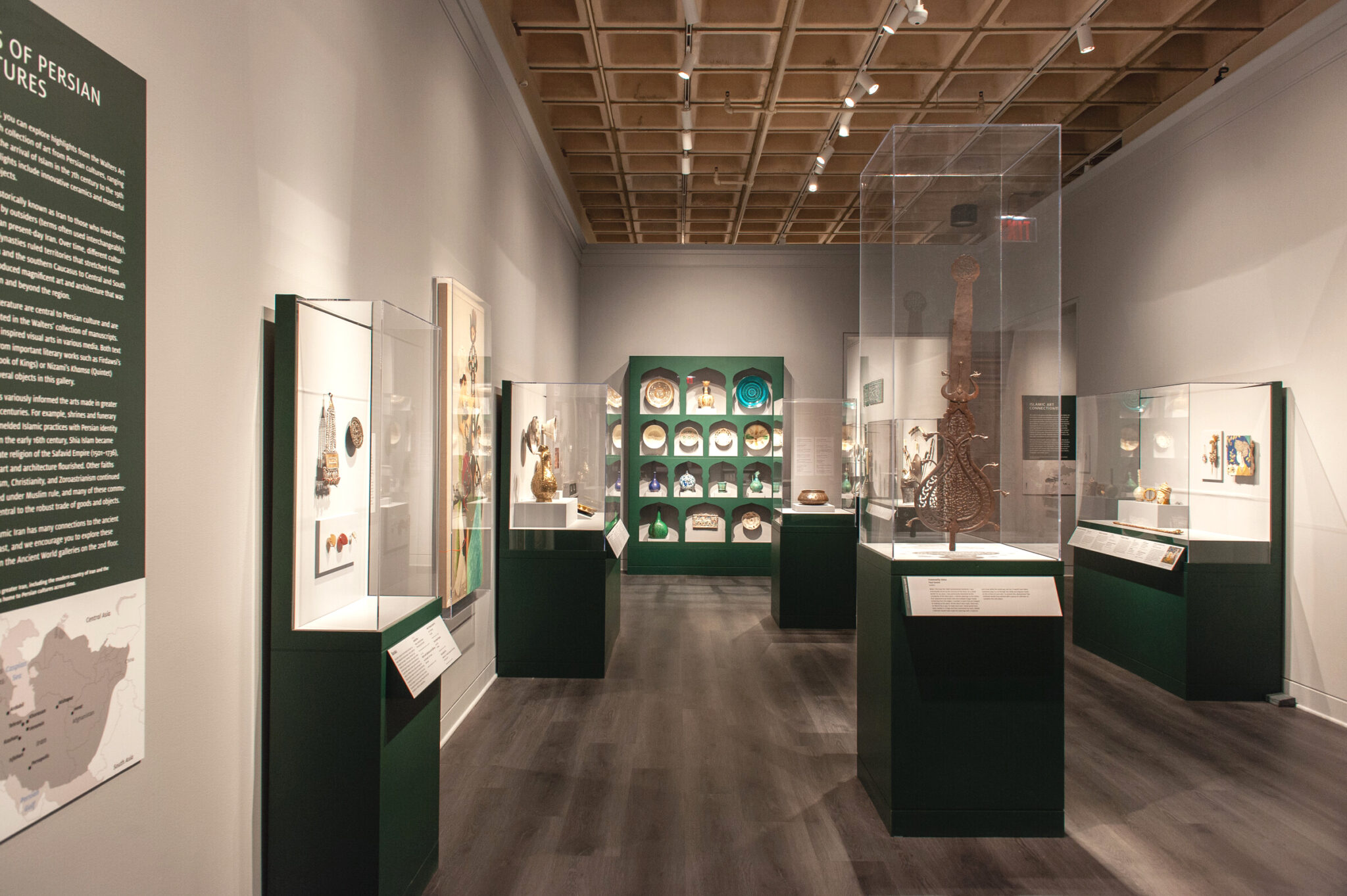 View of gallery with many art objects in cases