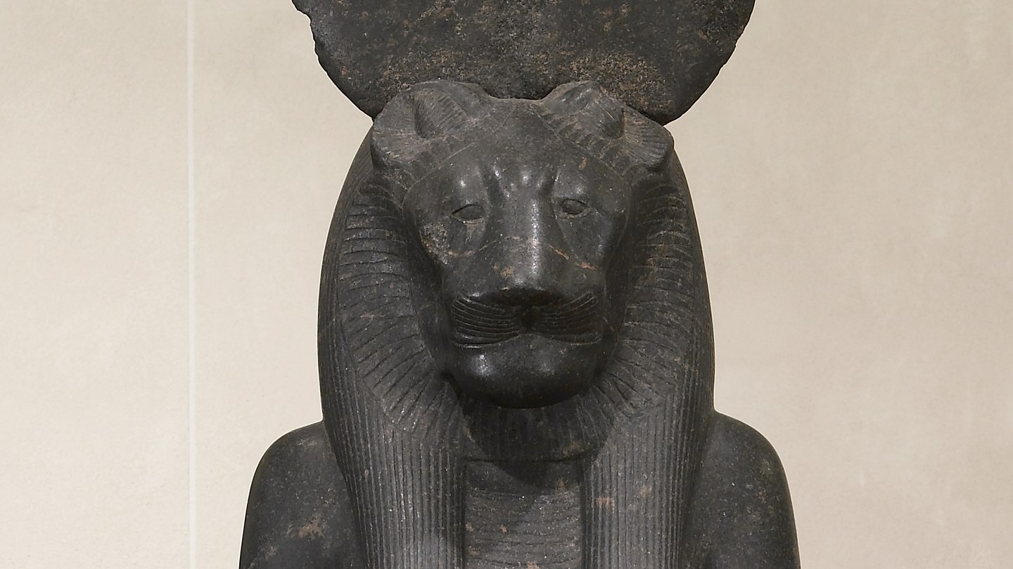 ancient Egyptian carved statue of Sekhmet, as a woman with the head of a lioness, on which was placed the solar disk.