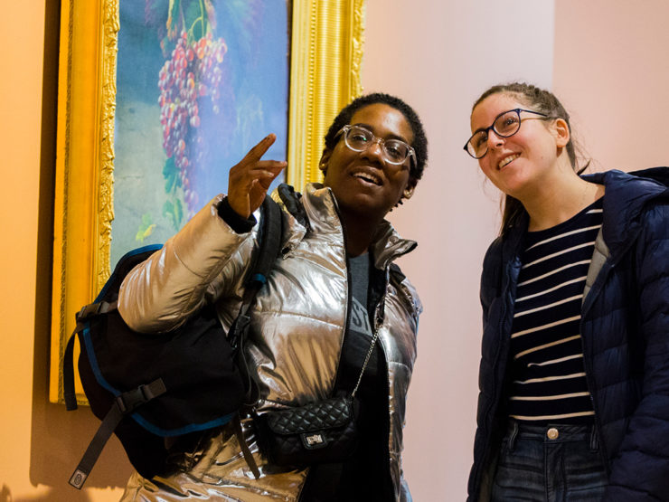 College students conversing in a museum gallery.