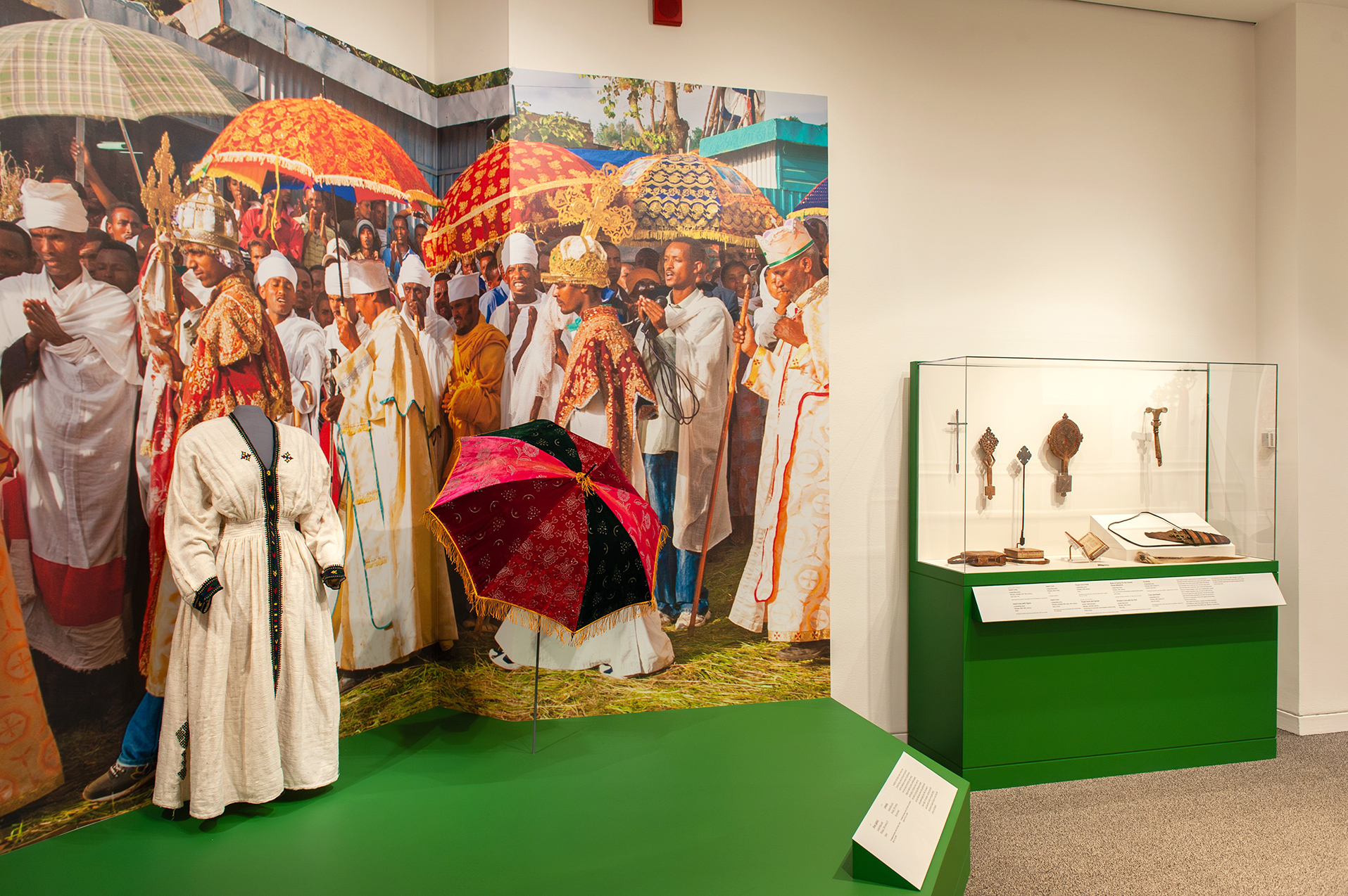 An in-gallery view of art objects and a large photo graphic in Ethiopia at the Crossroads