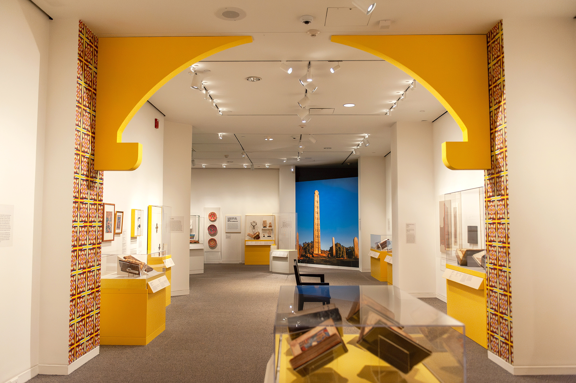 An in-gallery view of art objects and a built-in archway in Ethiopia at the Crossroads