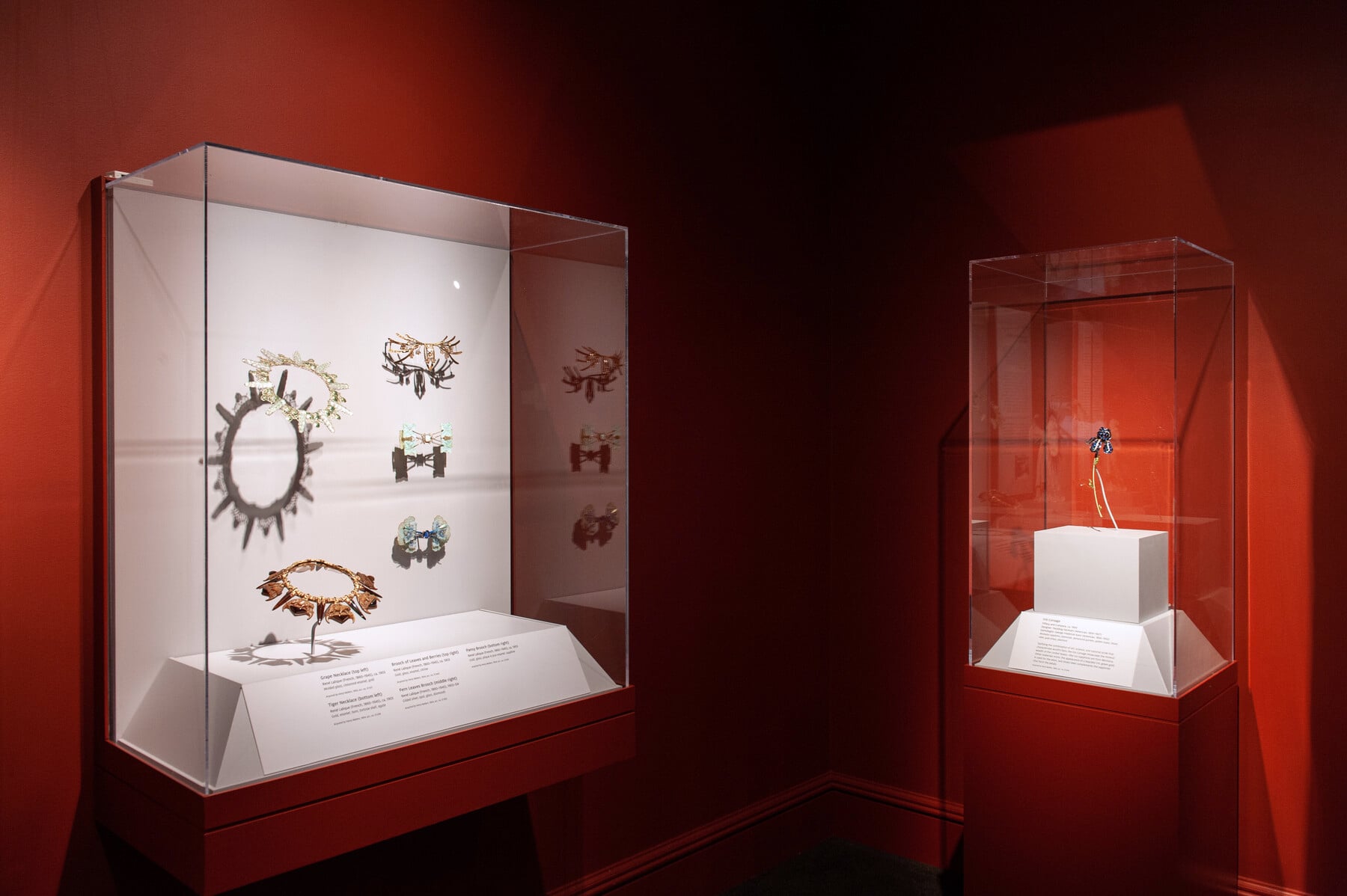 An in-gallery view of Distinctive Design with several cases of art objects
