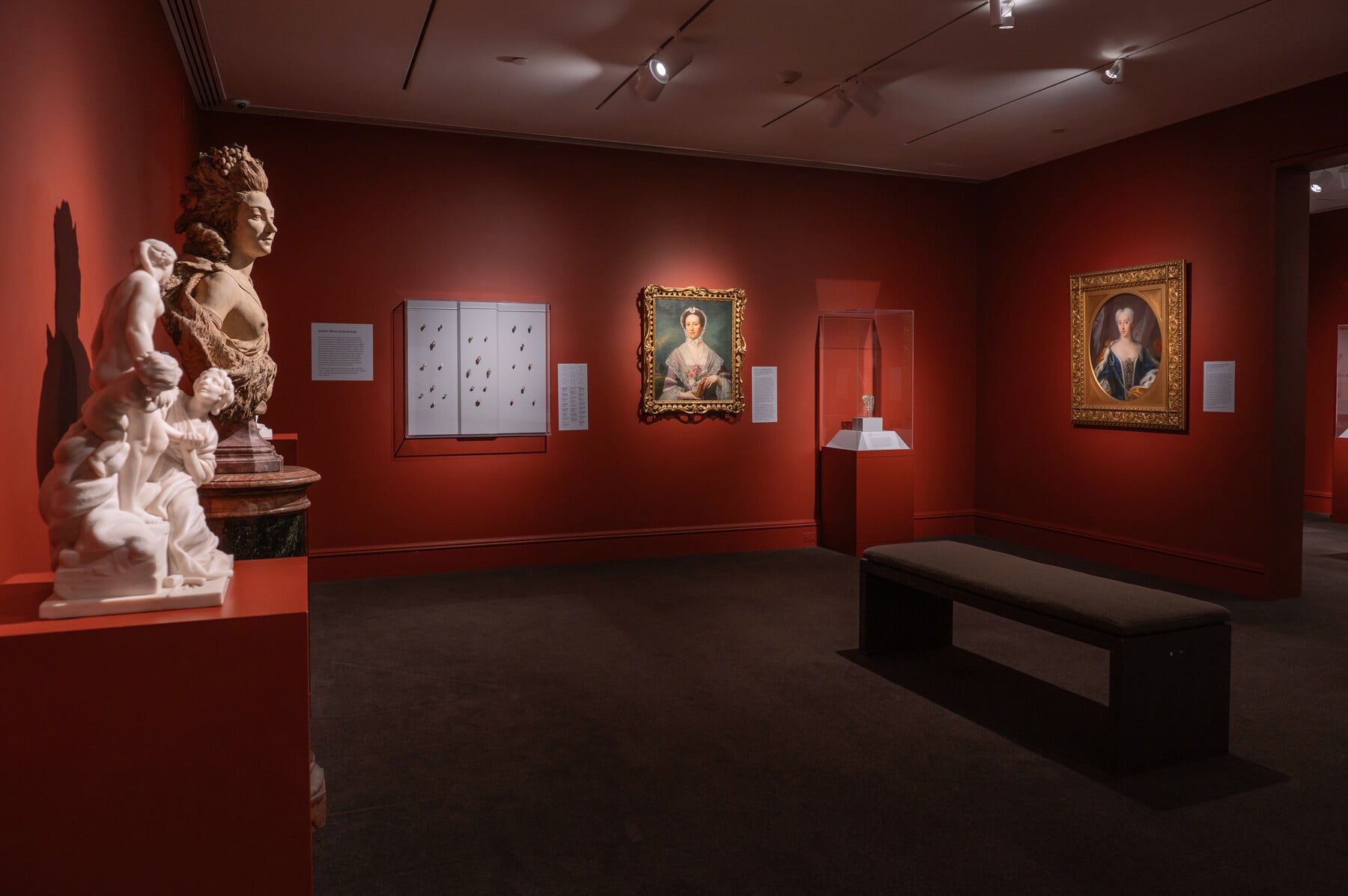 An in-gallery view of Distinctive Design with several art objects and paintings