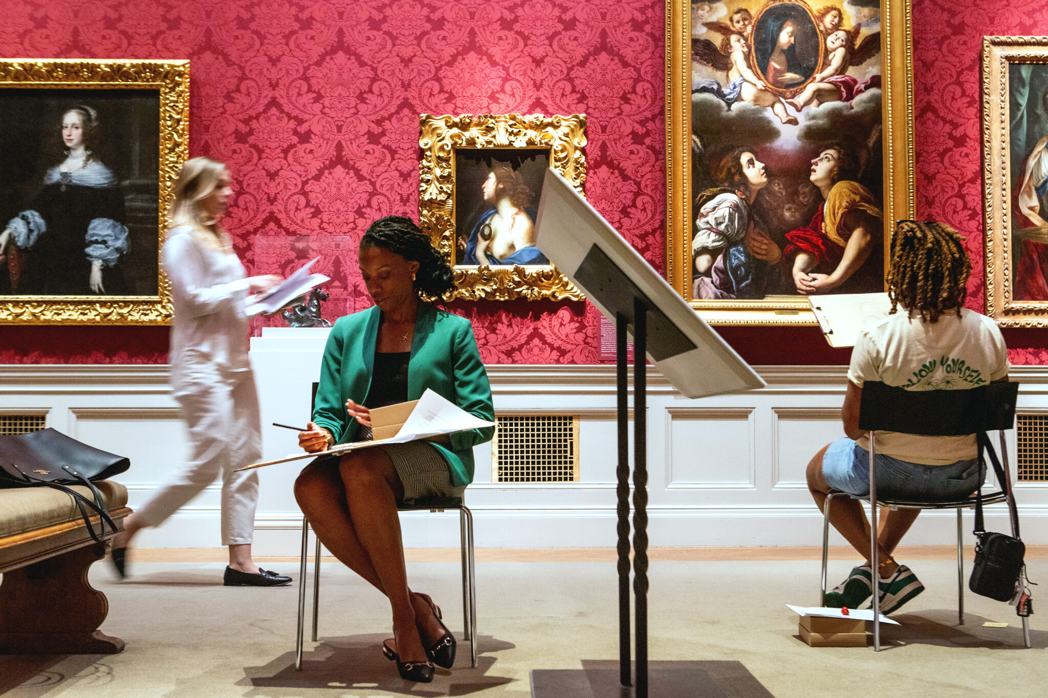 Visitors draw in a gallery