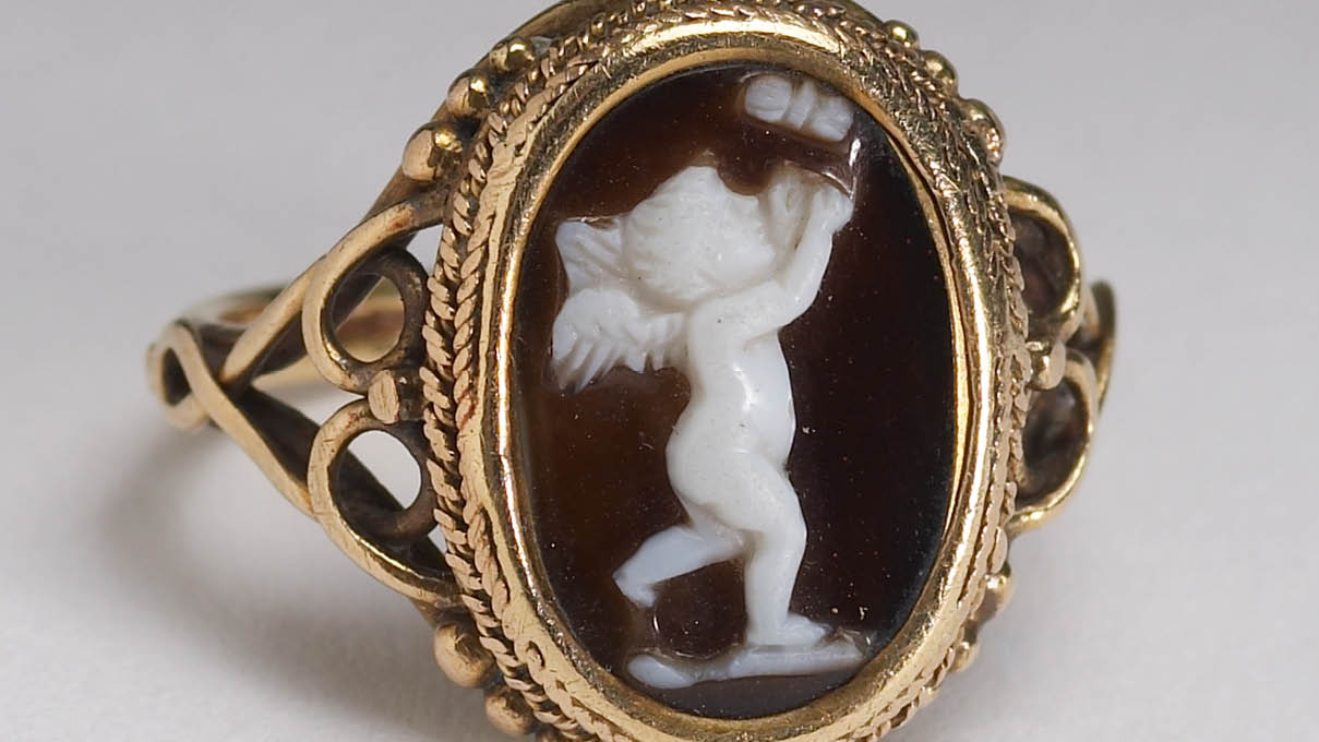 Ring with Cupid chasing a butterfly