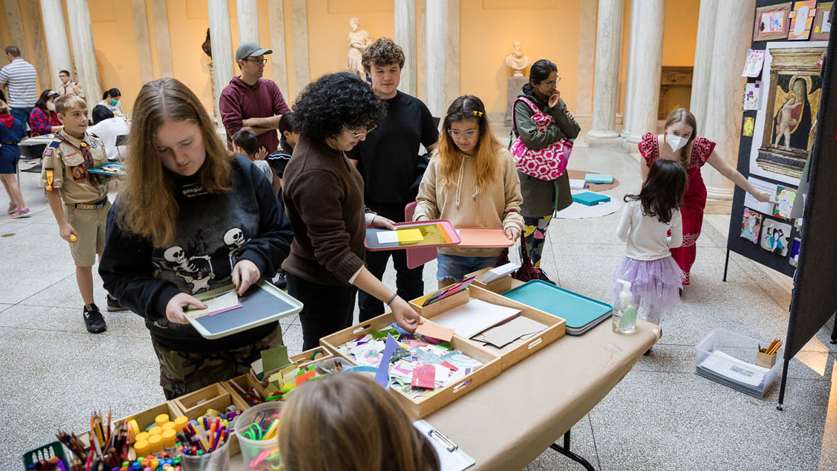 museum visitors making art together