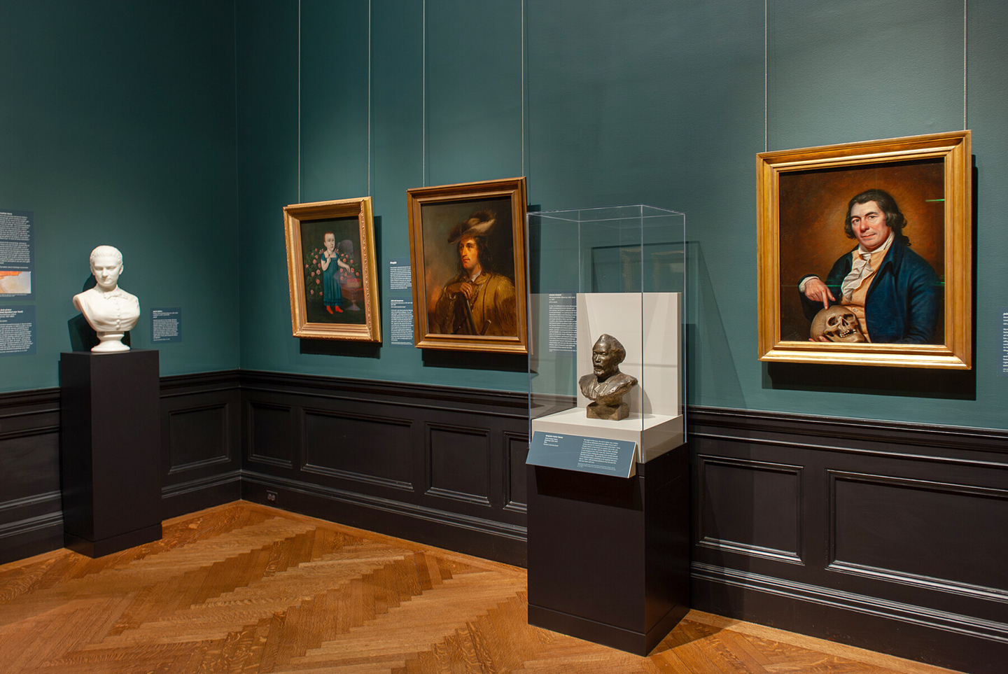 In-gallery view of Selections from the North American Collection: People and Places, which shows a sculpture and paintings.