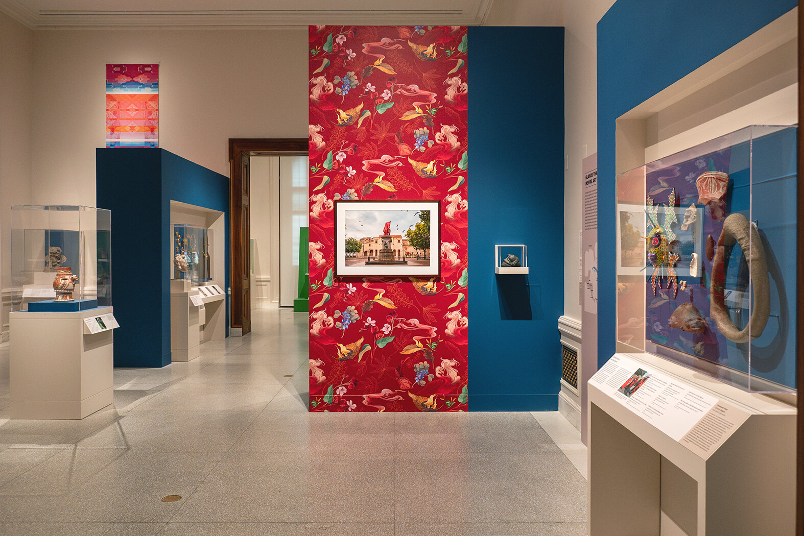 Patterned wallpaper, a contemporary art piece, covers part of one of the walls