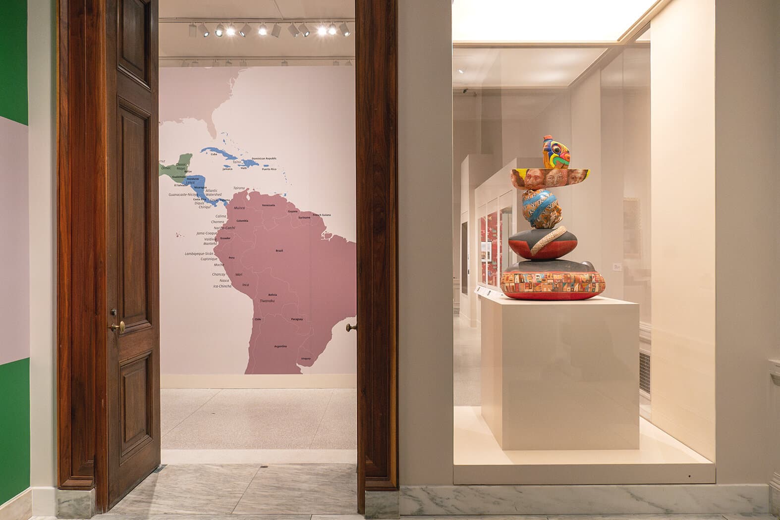 A view turned to the right of the title wall towards a large wall graphic of a map of Latin and South America