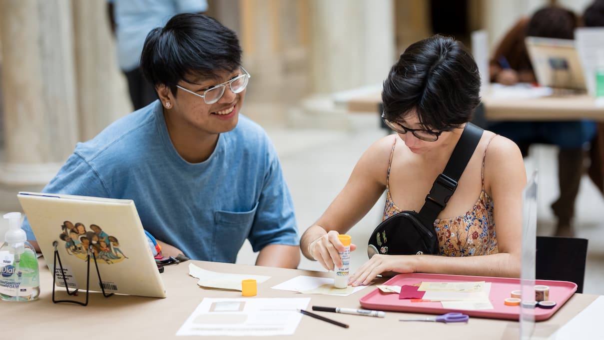 Museum visitors making a card together.