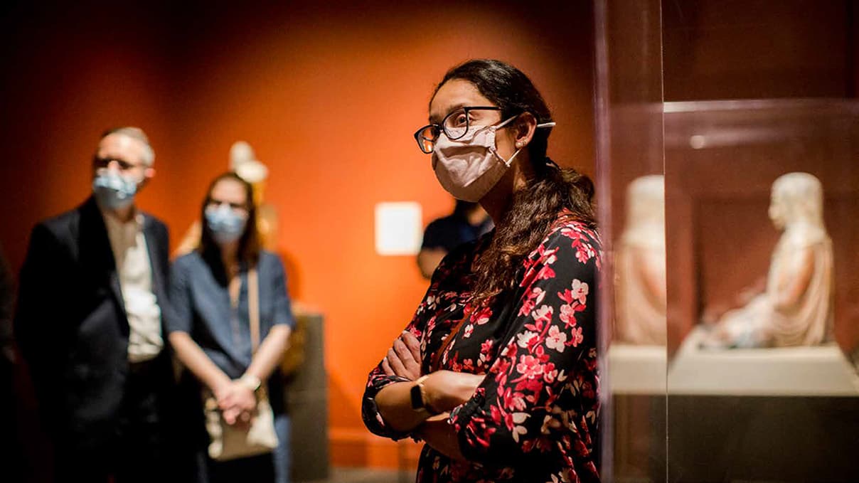 Listening to a docent during a museum tour