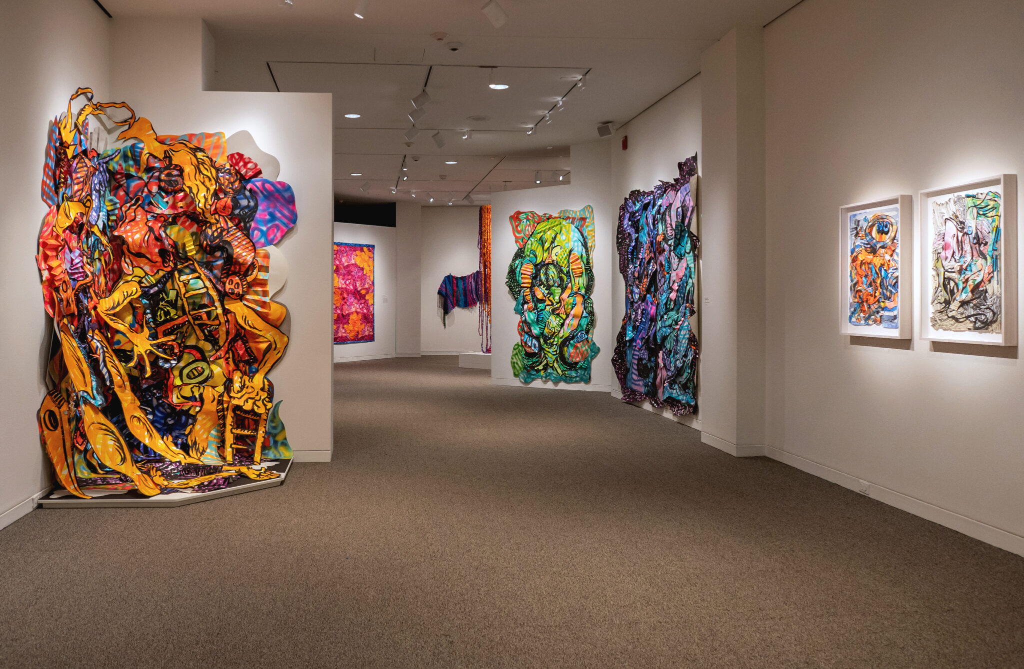 View of gallery with multiple pieces of artwork by Amanda Leigh Burnham