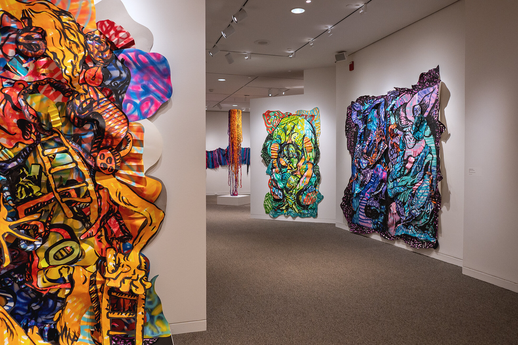 View of gallery with multiple pieces of artwork by Amanda Leigh Burnham