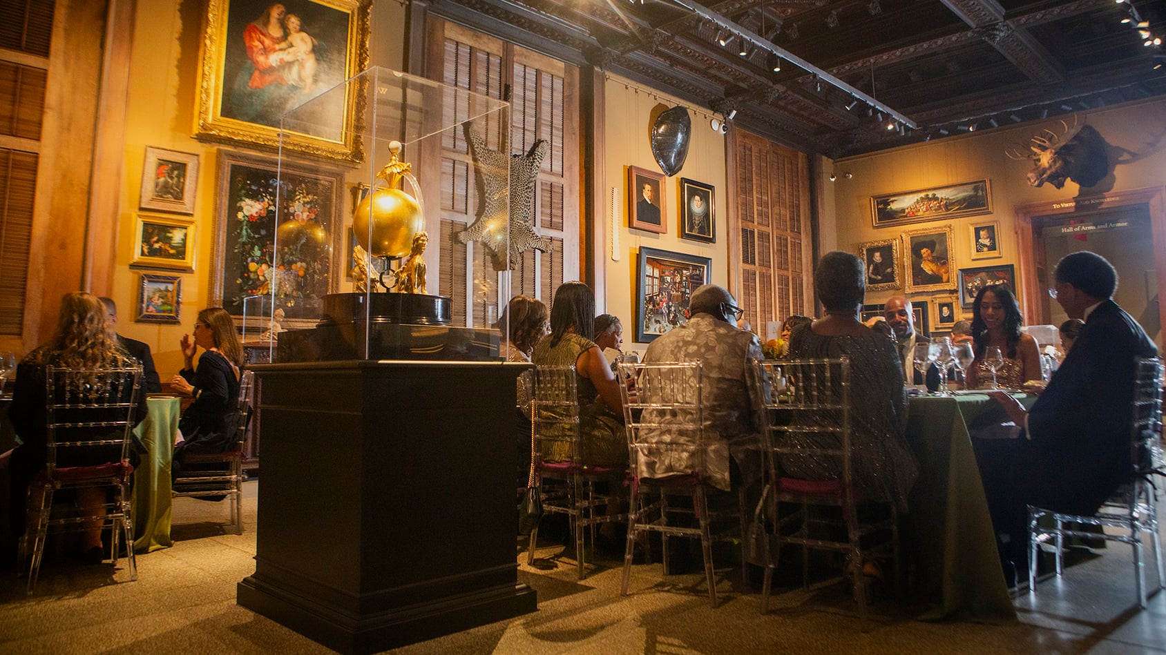Guests at dinner tables in a Walters gallery hung with paintings, at the 2025 Gala.