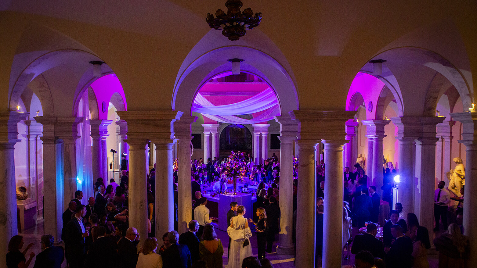 Colored lights shine on guests attending the Gala in the Sculpture Court