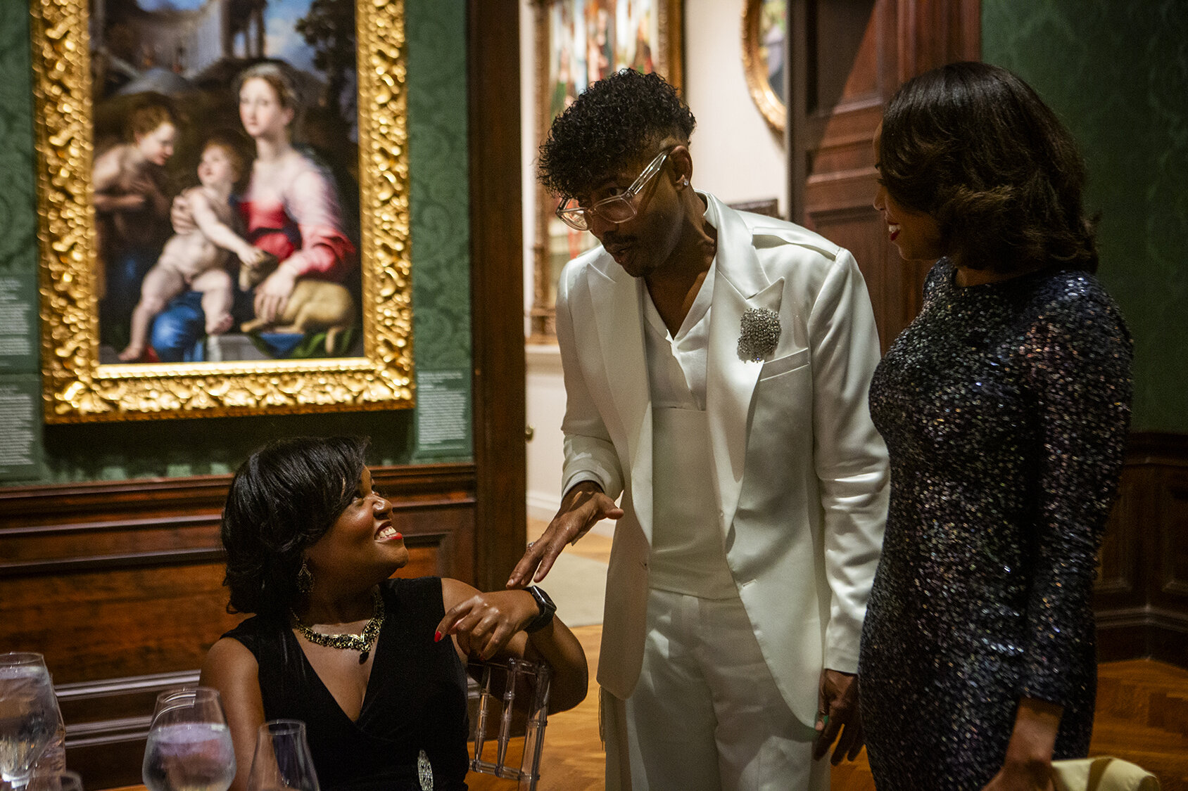 Seated and standing guests in a gallery during the gala