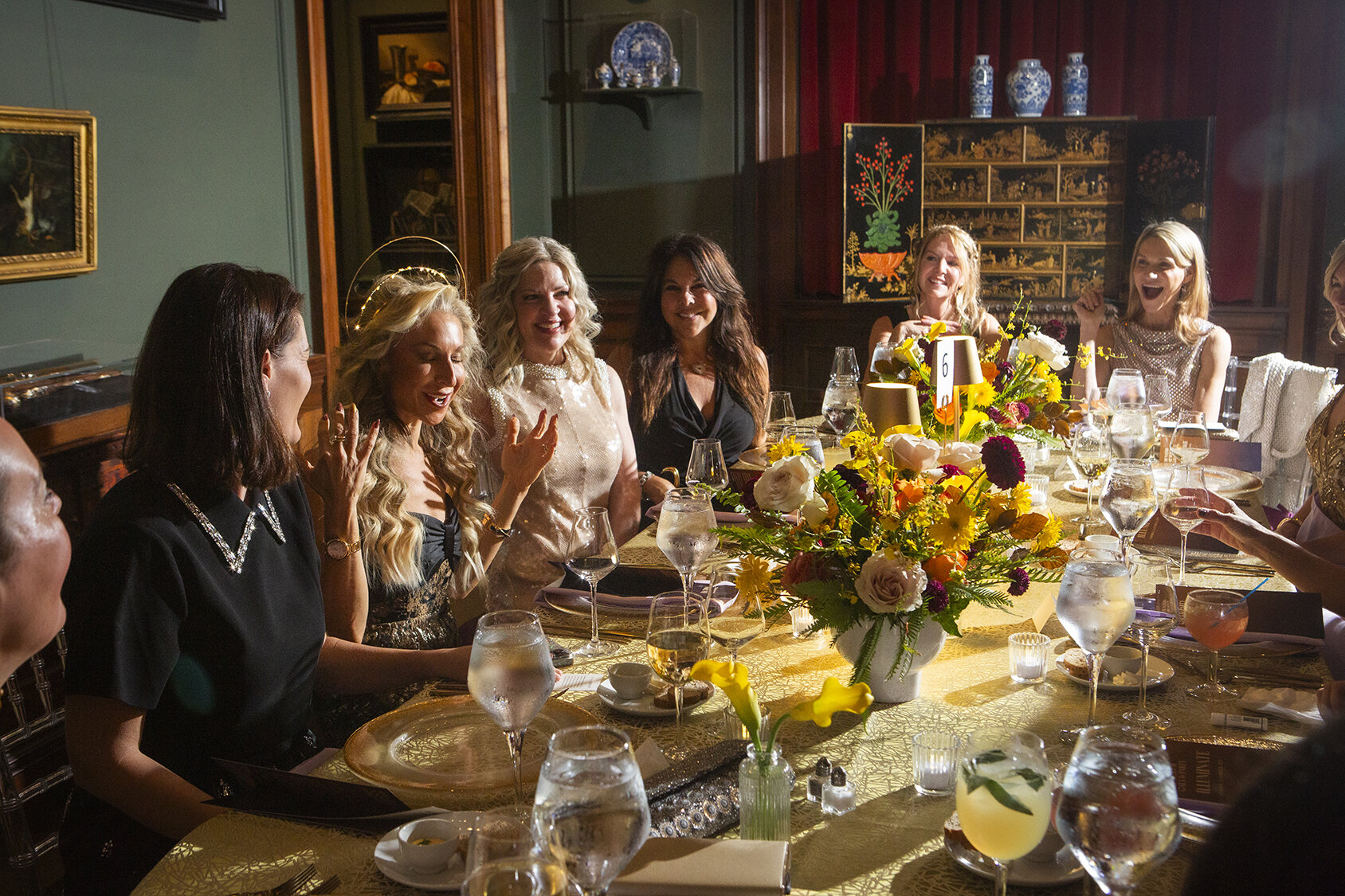 A group of guests around a table in a gallery during the gala