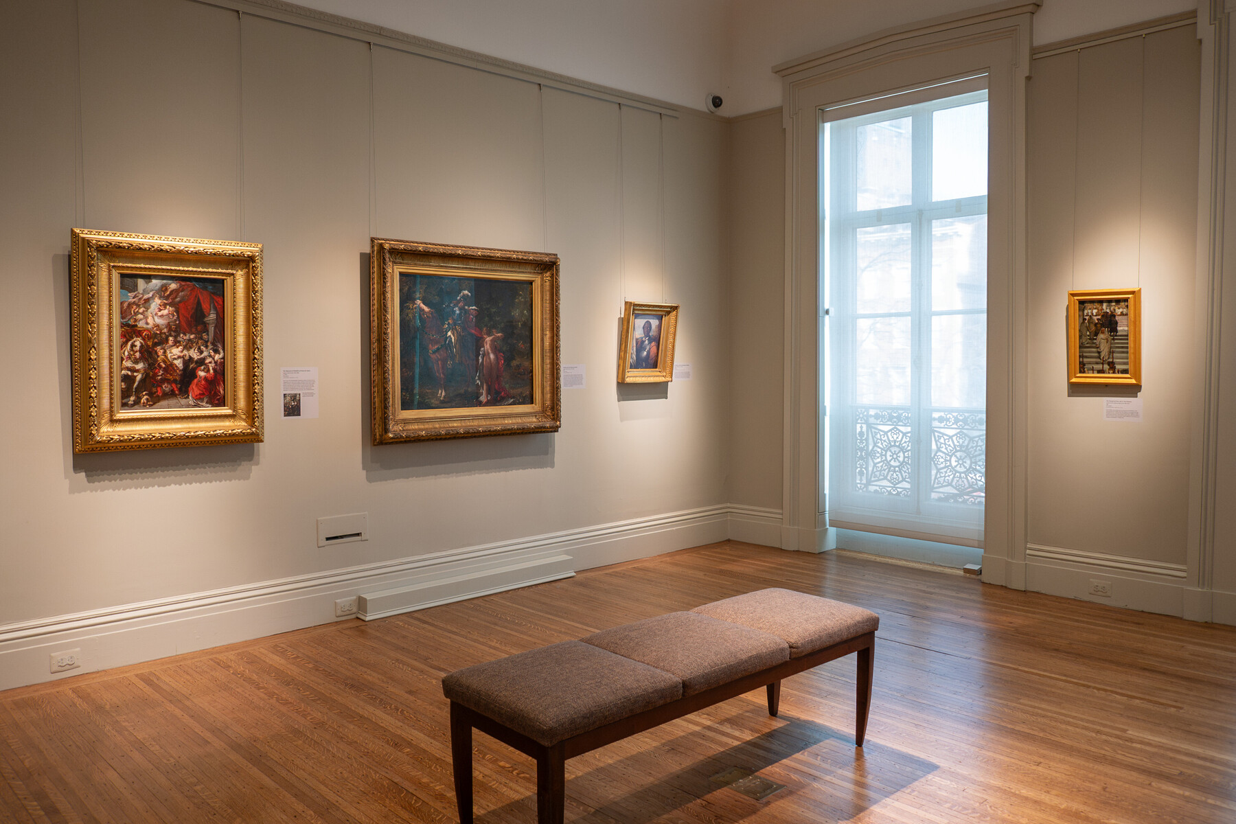 Several paintings hanging in a gallery