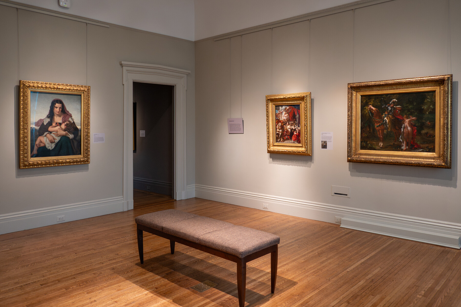 Several paintings hanging in a gallery