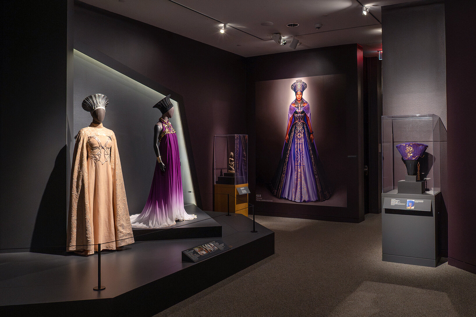 Mannequins and a large wall graphic in the exhibition Douriean Fletcher: Jewelry of the Afrofuture