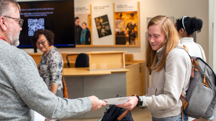 Volunteers assisting a museum visitor