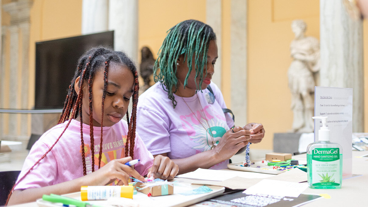 adult and child making art together in the gallery