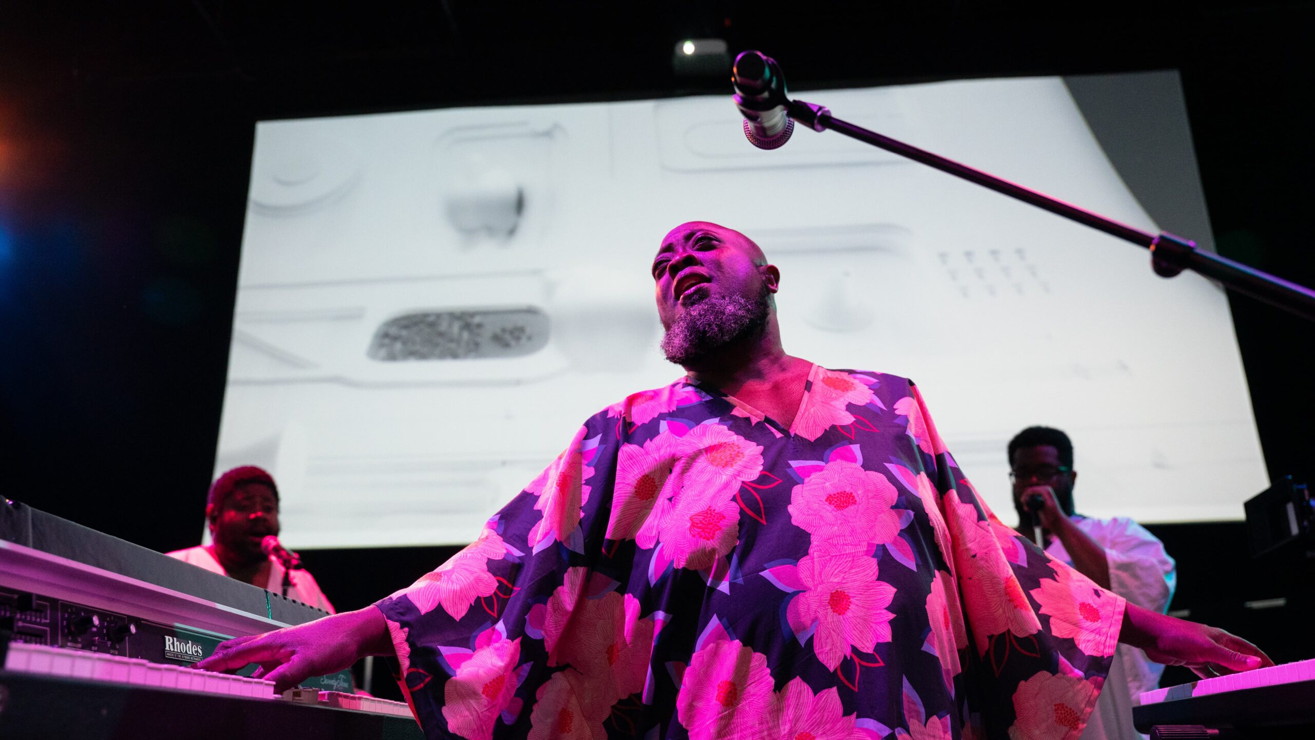 Afro House performers singing and playing keyboards
