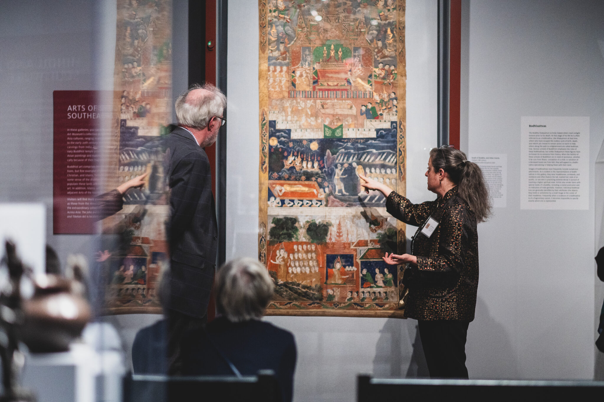 A curator leads visitors on a gallery tour