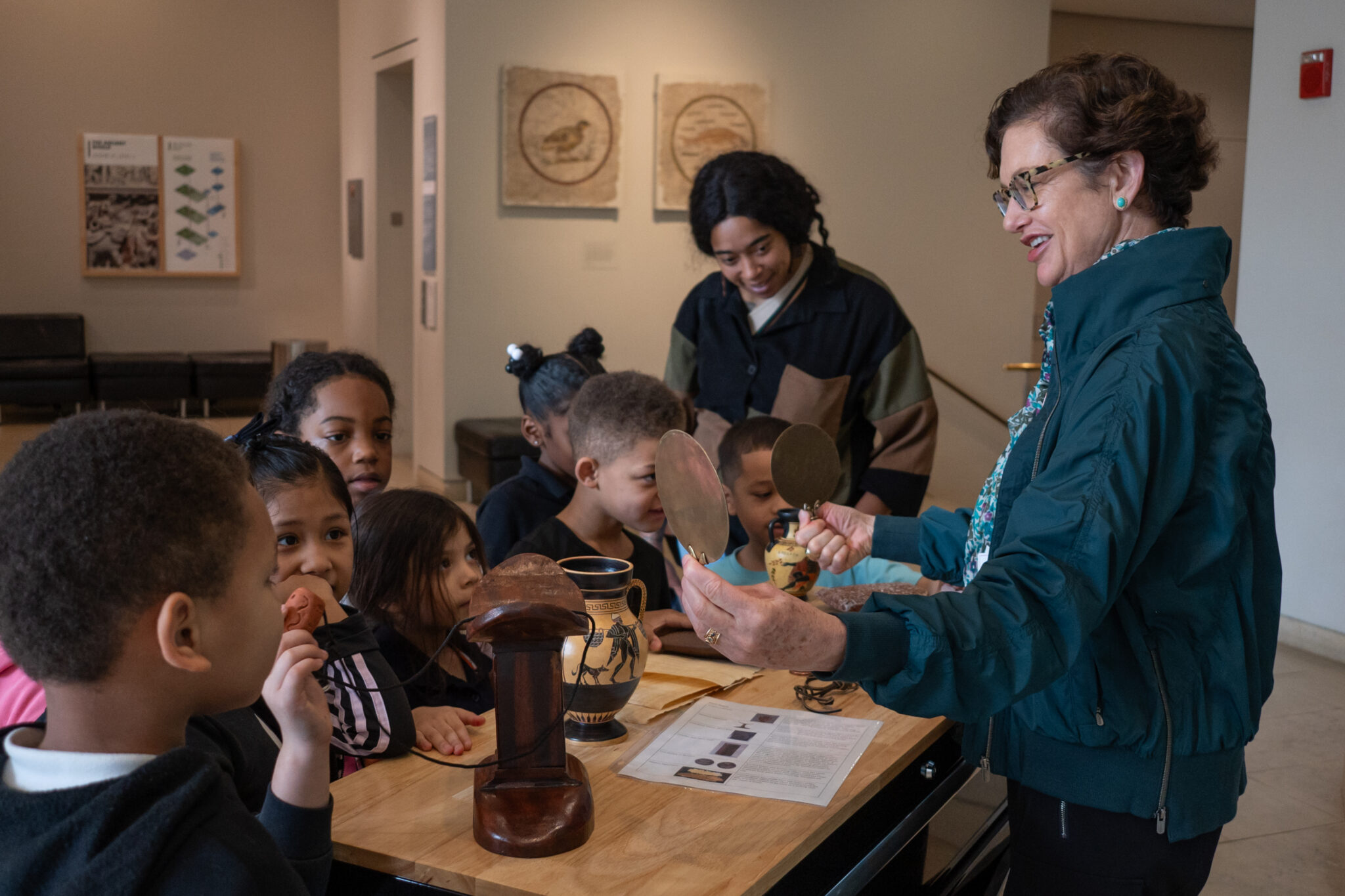 A group of young visitors see and touch a variety of traditional art materials