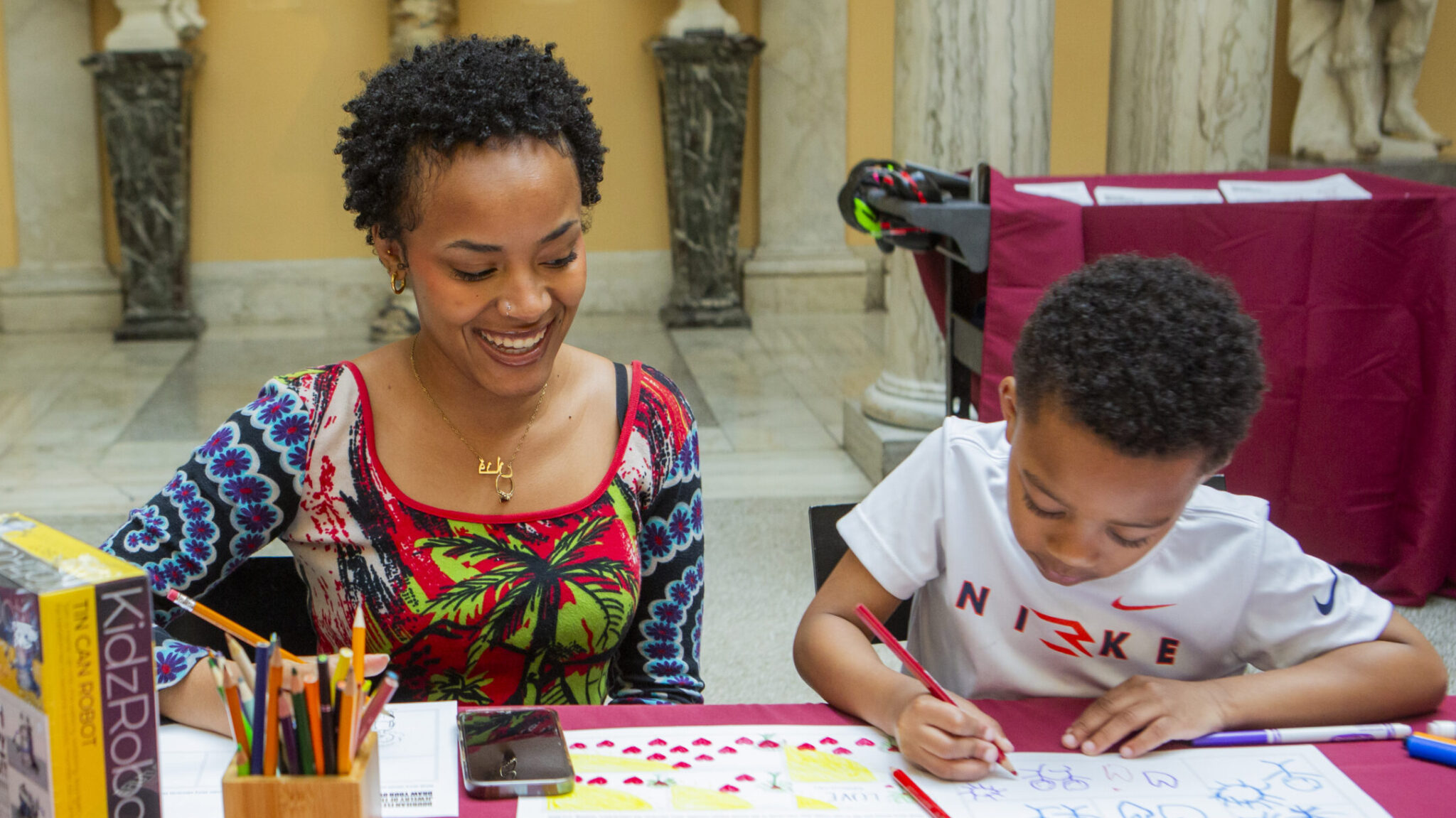 Visitors use art-making materials in the Sculpture Court of the Walters Art Museum