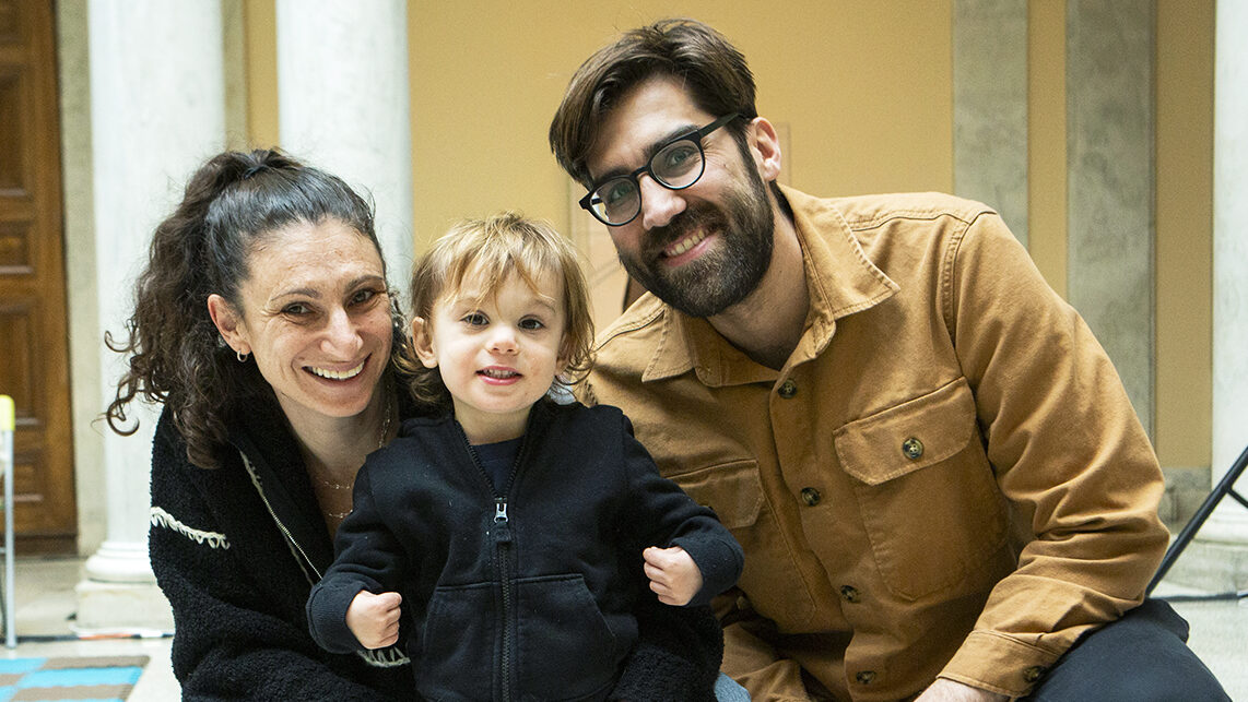 A visiting family smiles in the Sculpture Court