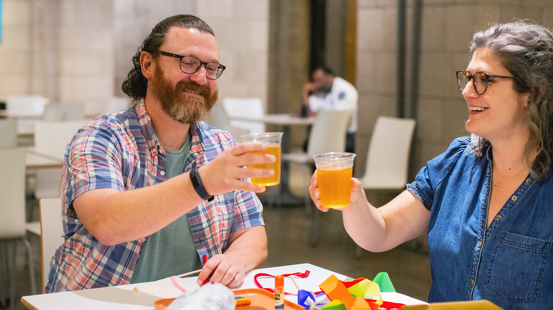 Visitors in the cafe cheers beverages while making art