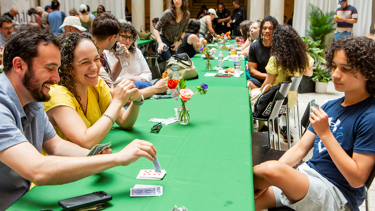 playing card games on a long green table