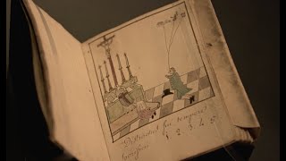 medieval manuscript held open in moody light