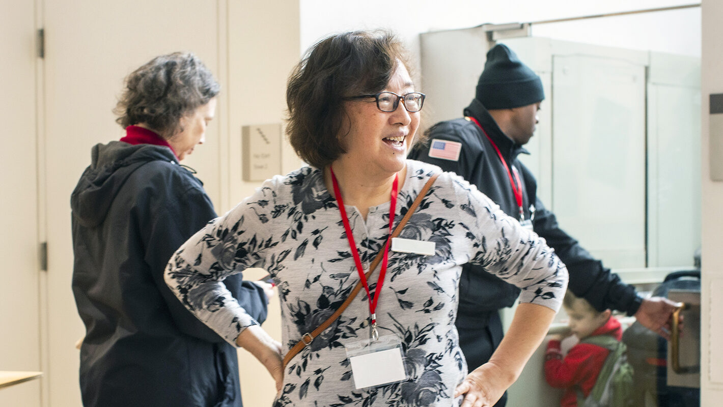 A volunteer stands in the entrance atrium