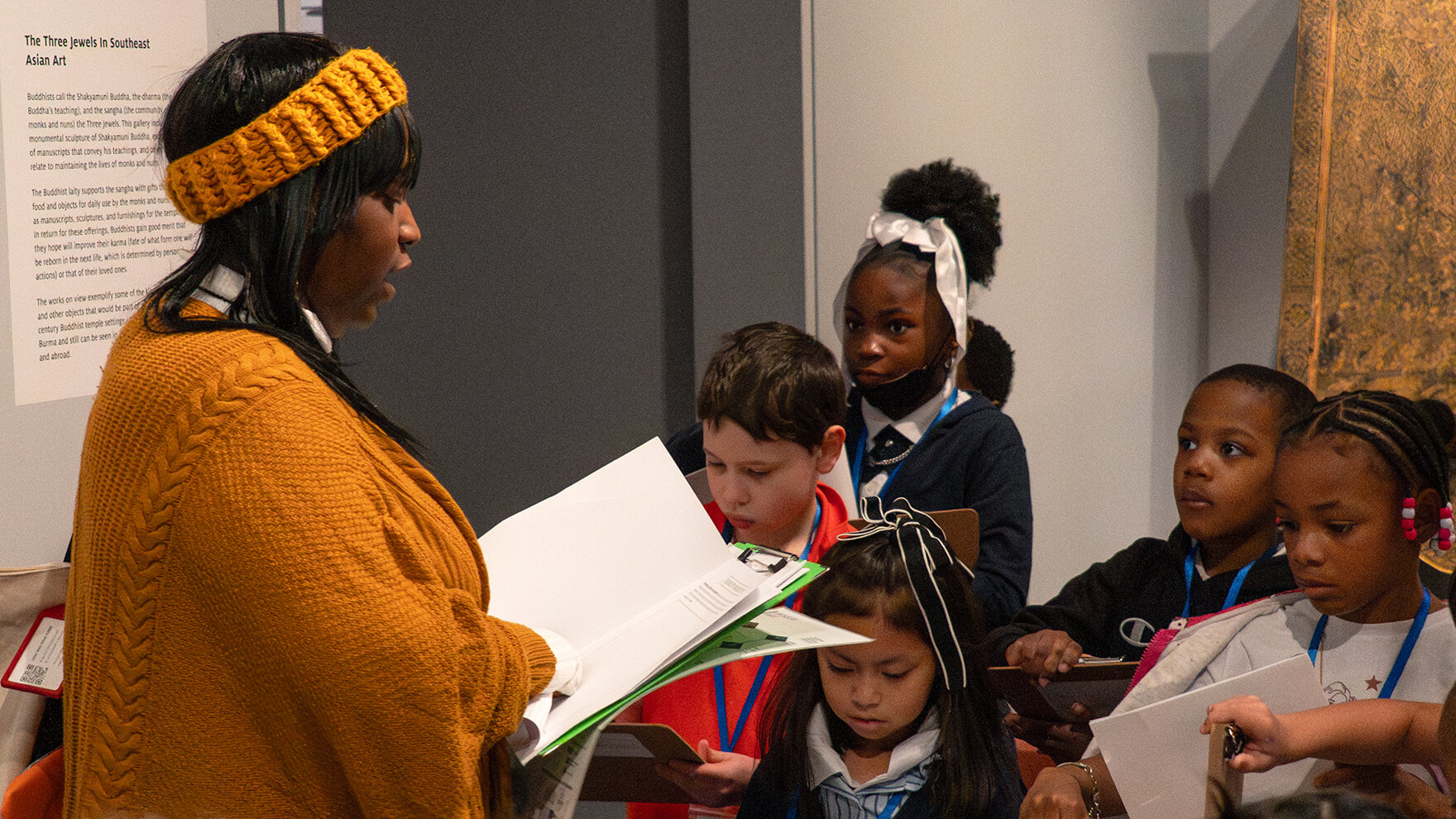 A teacher leads students on a field trip in the museum