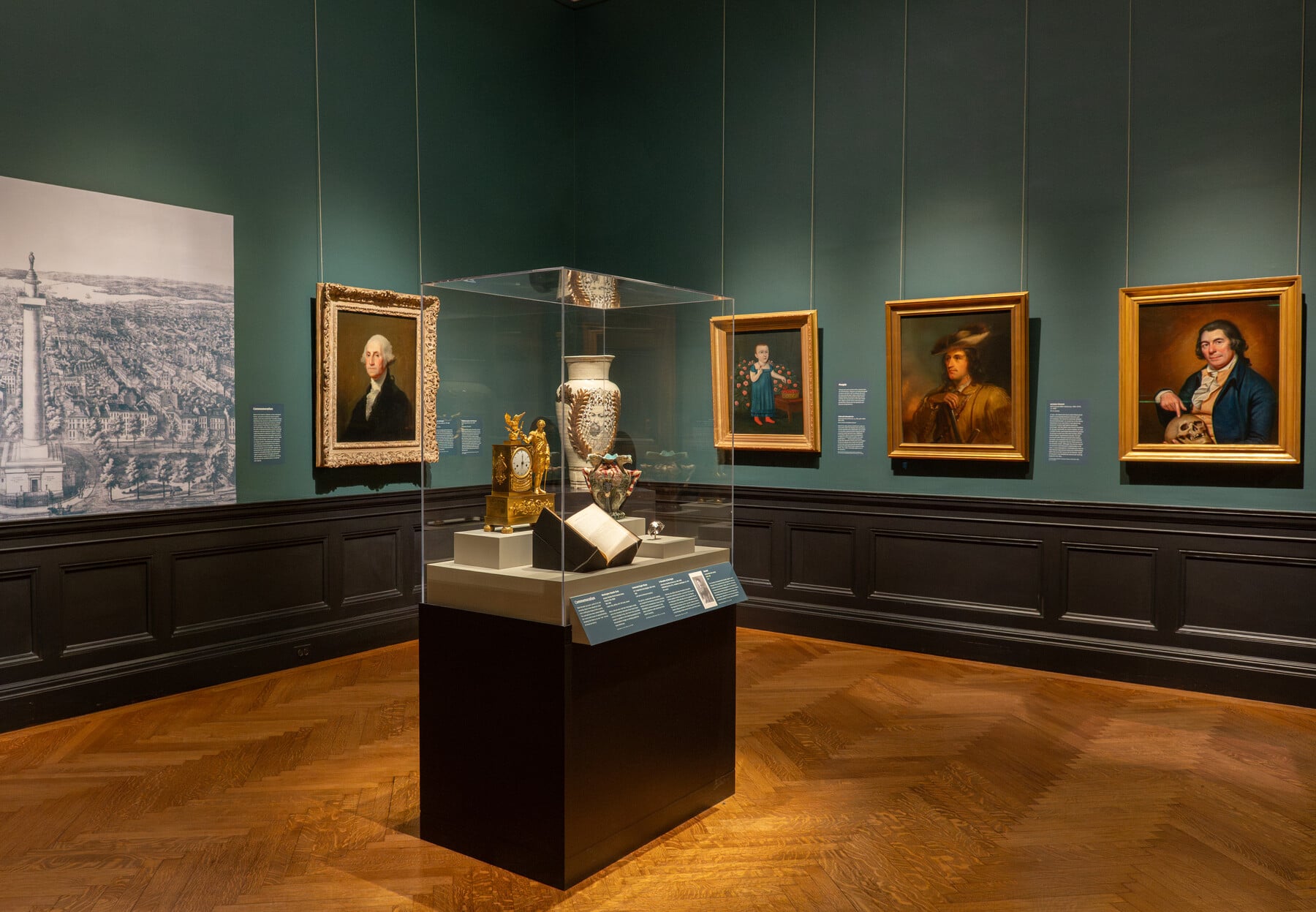 Gallery view of the United States at 250 with paintings and a case with art objects