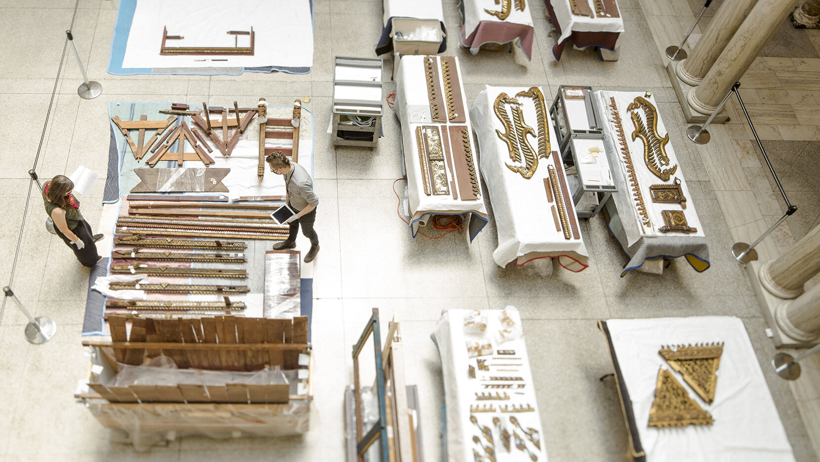 Conservators work on treating and reassembling a Thai Thammat in the Sculpture Court