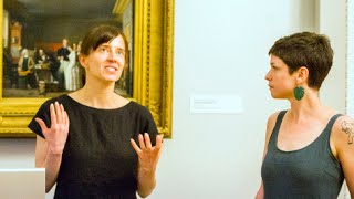 artists talking in front of a painting
