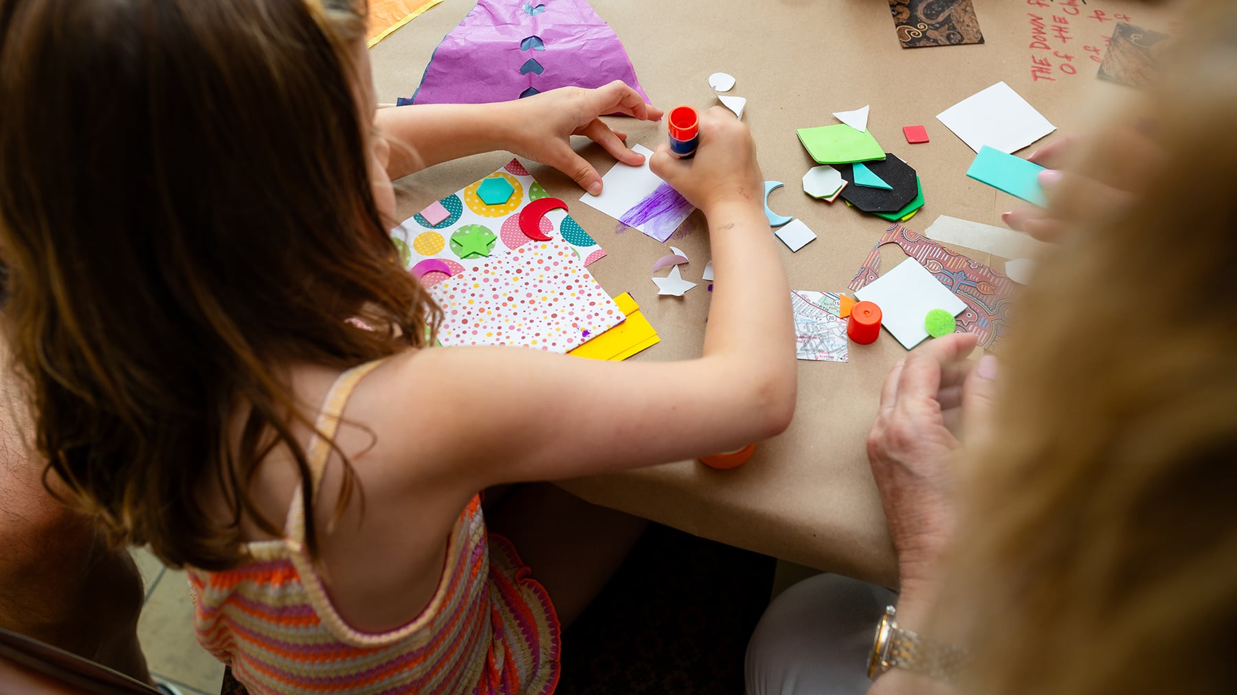 A young visitor uses art making supplies at a museum event